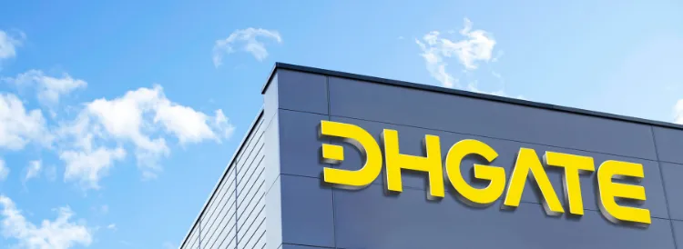 DHgate building with yellow company signage against a blue sky