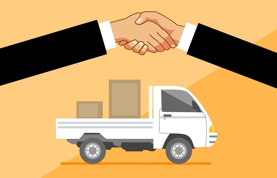 Illustration of a delivery truck carrying parcels beneath a handshake