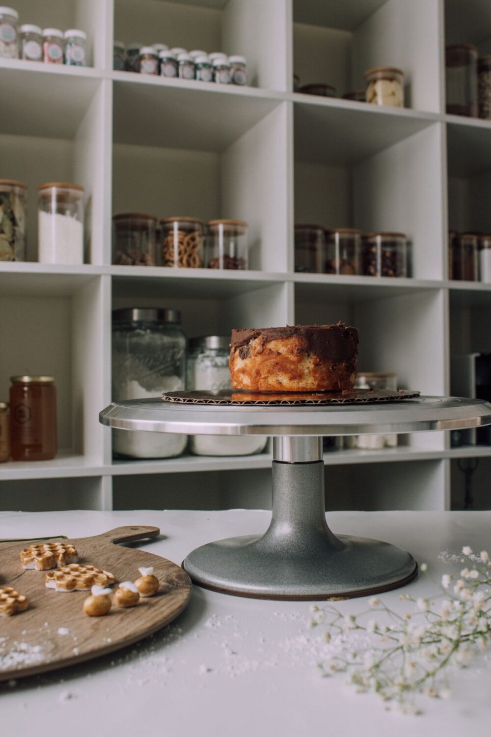 Freshly baked cake displayed on a silver cake stand