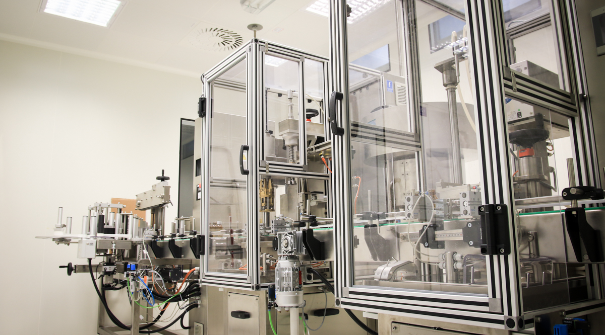 A cosmetics production line with stainless-steel processing equipment in a manufacturing facility