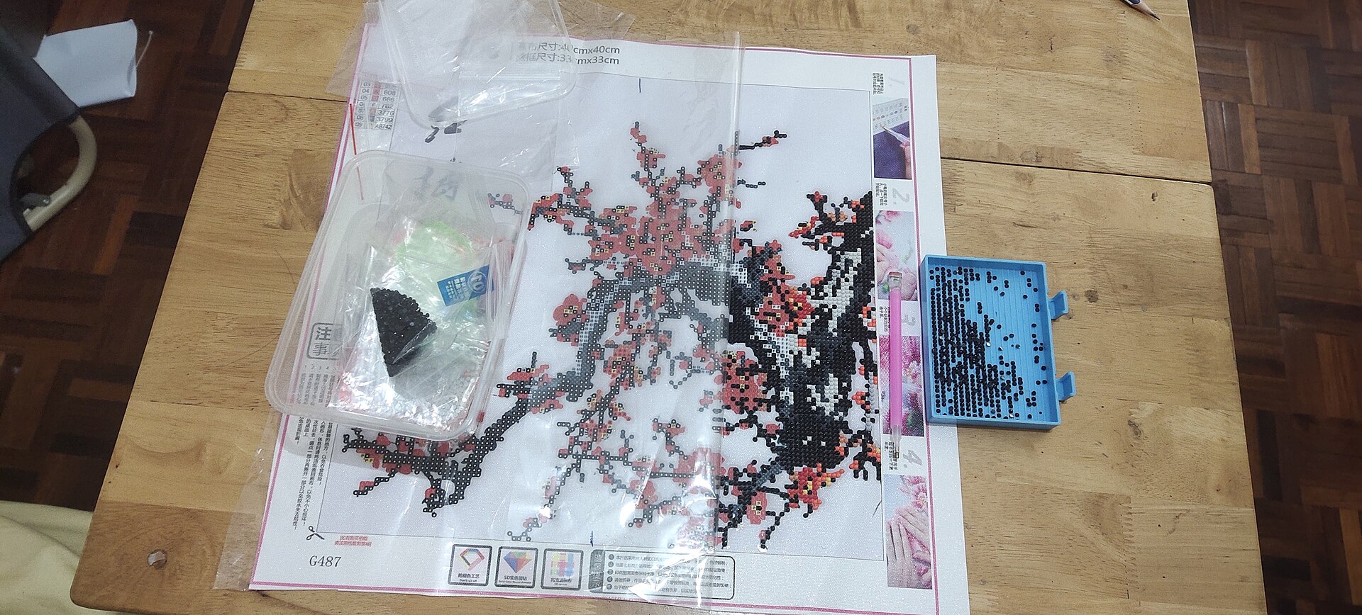 An unfinished diamond painting showing the small resin drills placed across a printed canvas