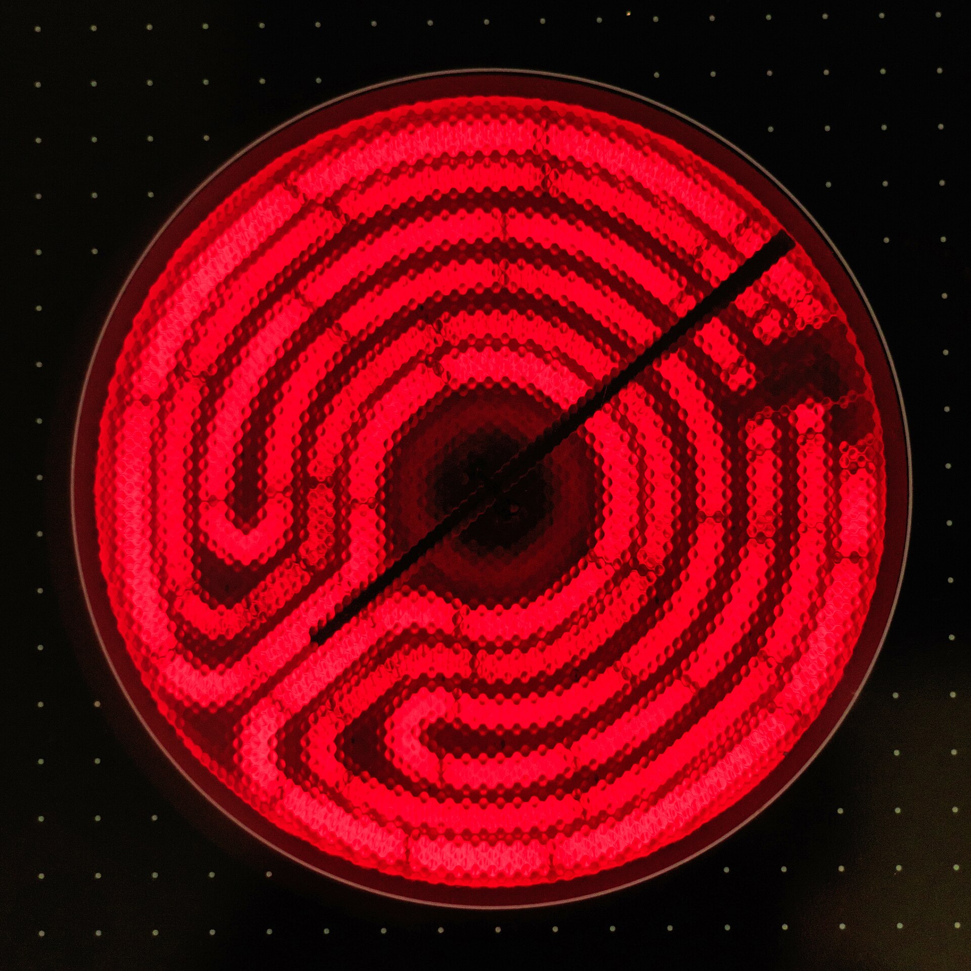 A glowing electric cooktop element, illustrating the different heating surface used by stovetop cookware