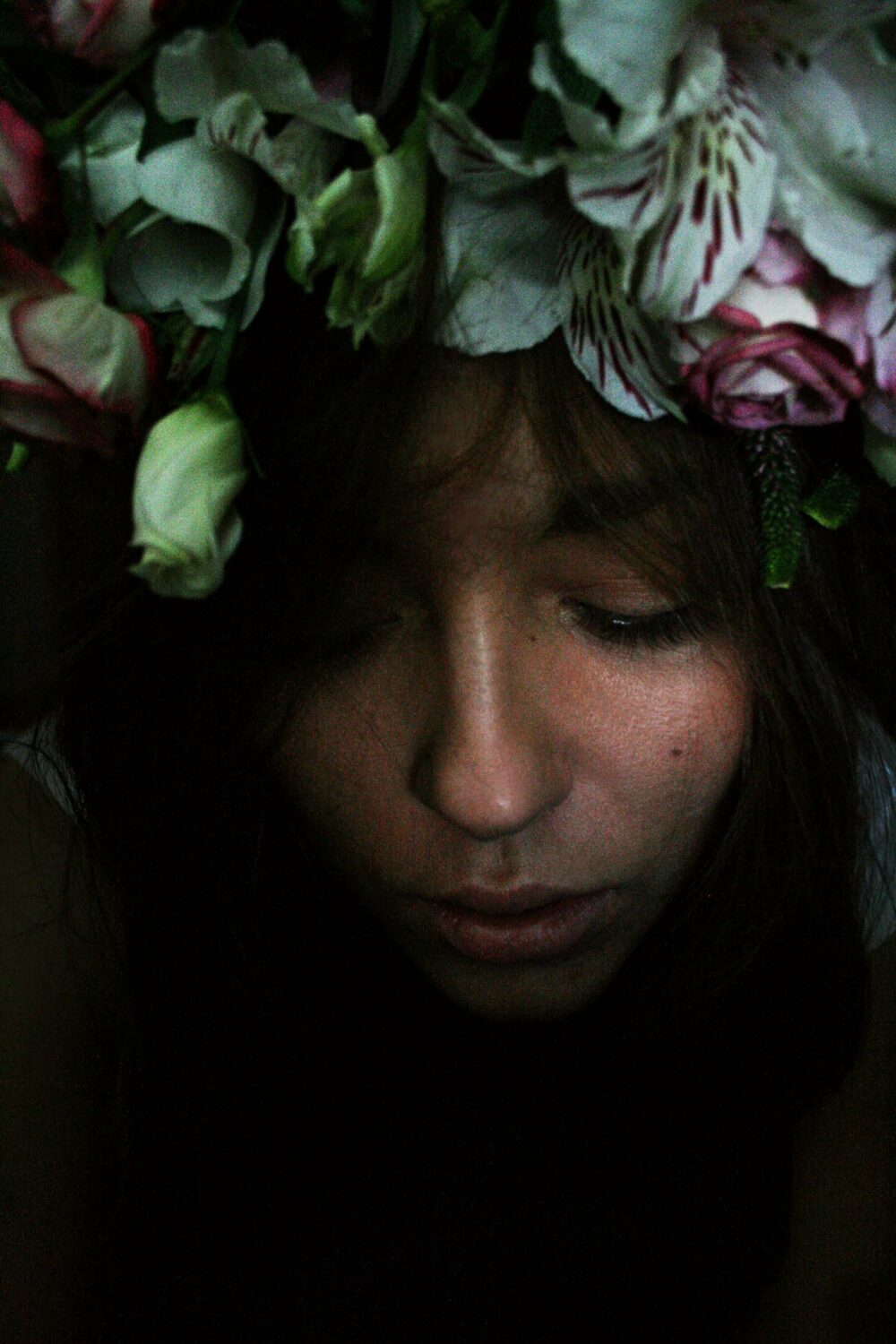 Woman wearing a floral headband, illustrating how flower placement and scale affect the finished look