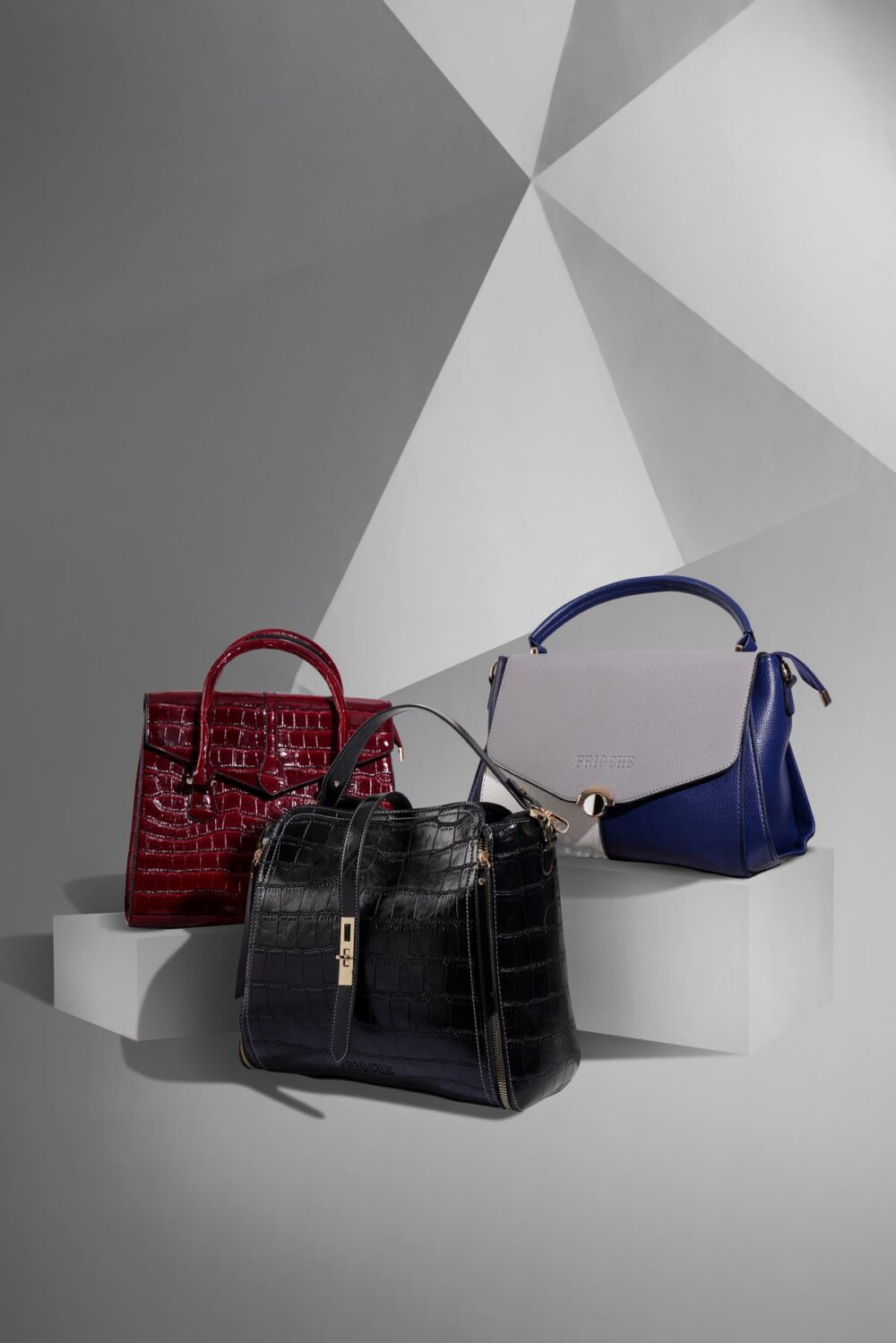 Black and red handbags arranged in a studio