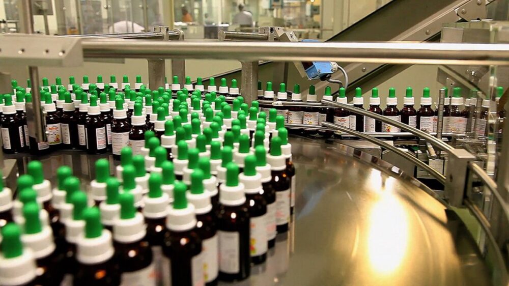 Cosmetics manufacturing line with bottles on a conveyor