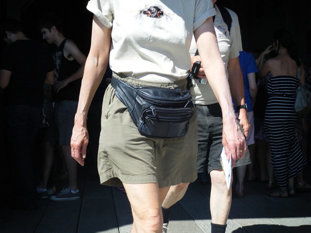 Close-up of a leather fanny pack lying on a surface, illustrating materials and hardware choices for custom belt bags