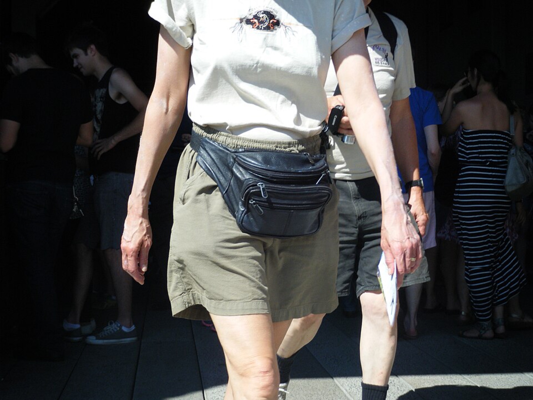 Close-up of a leather fanny pack lying on a surface, illustrating materials and hardware choices for custom belt bags