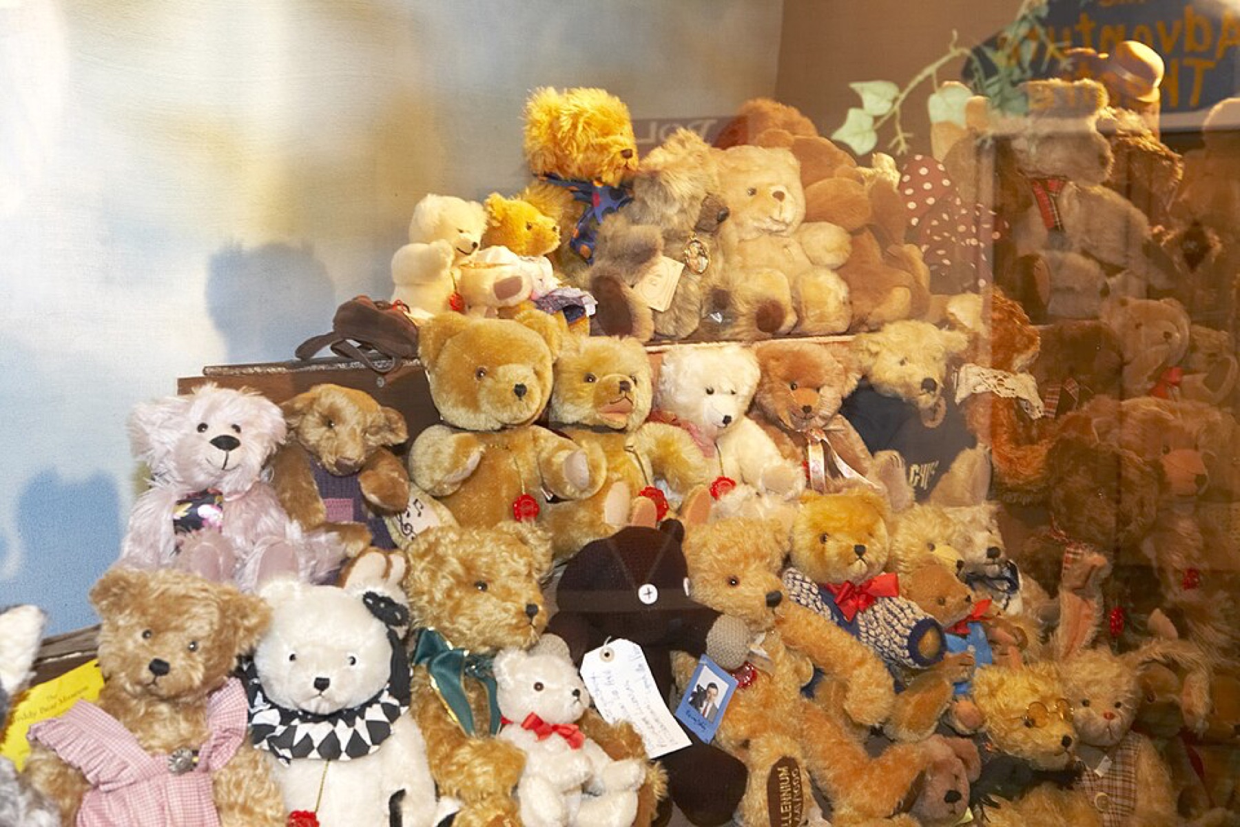 assorted teddy bear plush toys in different colors and sizes arranged together