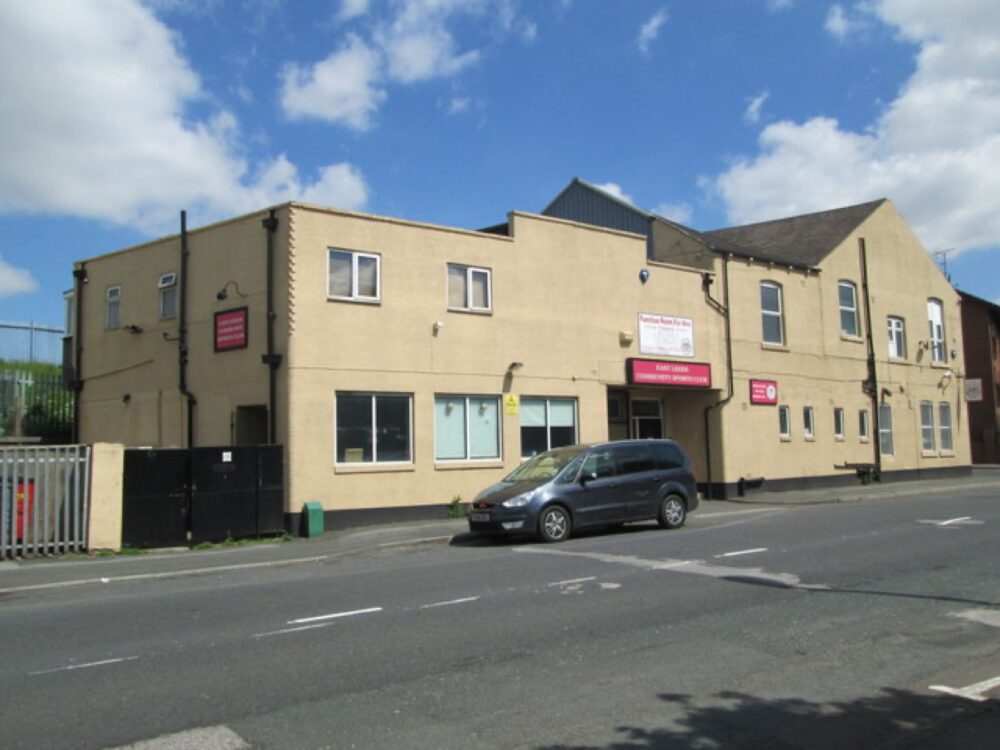 Community sports club building with playing fields in front