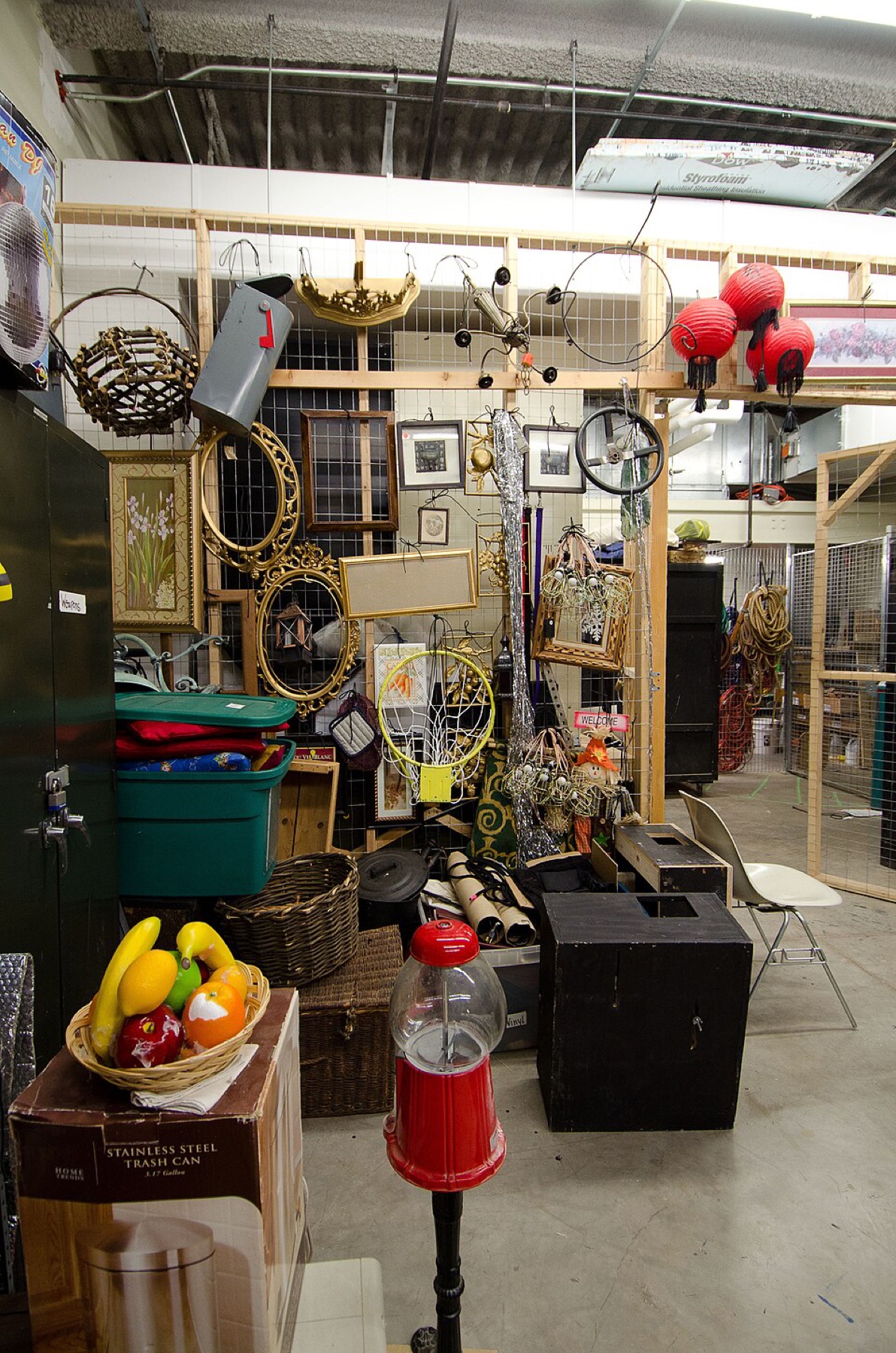 Prop room filled with assorted theater and set props on shelves.