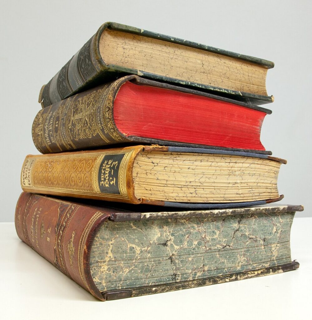 Stack of old books illustrating physical print choices