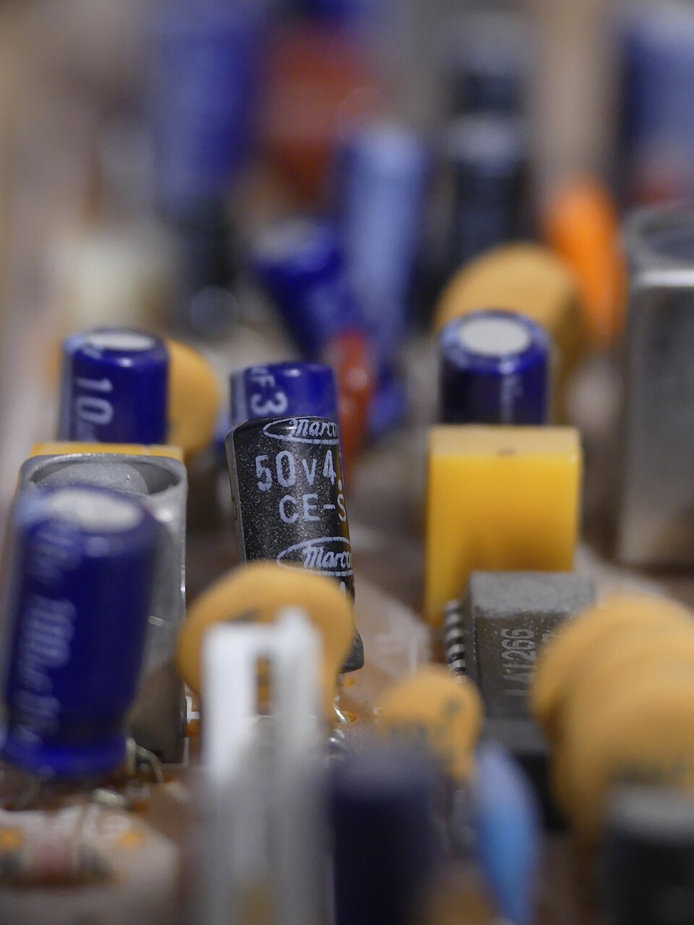 Assorted electronic components including resistors, capacitors, and ICs laid out on a table