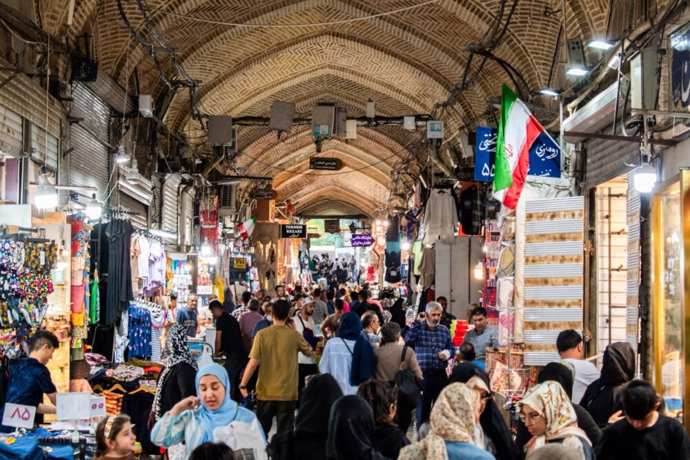 Busy covered bazaar with stalls and shoppers, illustrating bazaar-style marketplace variety