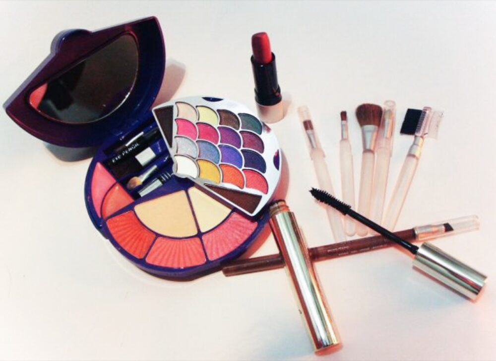 Assorted cosmetics including blush and brushes