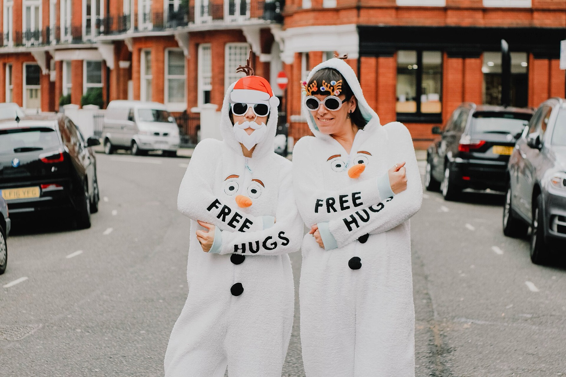 Adults wearing festive Christmas jumpers at a holiday event