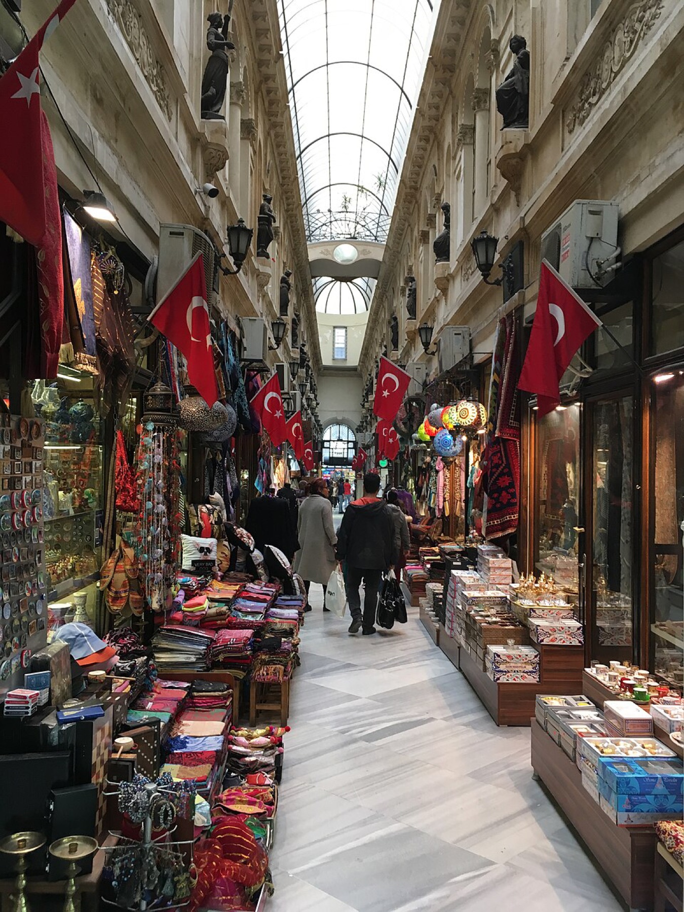 Crowded Turkish bazaar with clothing and textiles on display