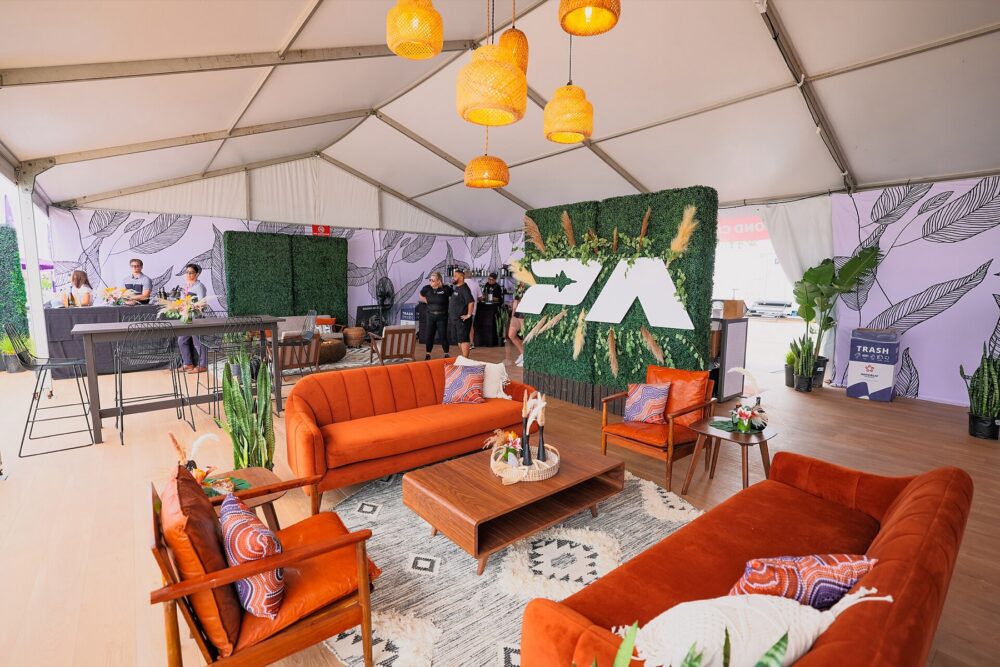 Outdoor event furniture setup with folding seating under tents