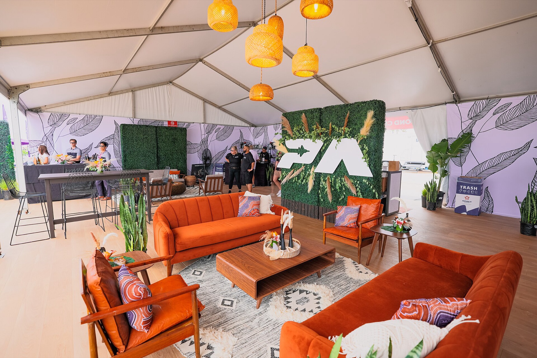 Outdoor event furniture setup with folding seating under tents