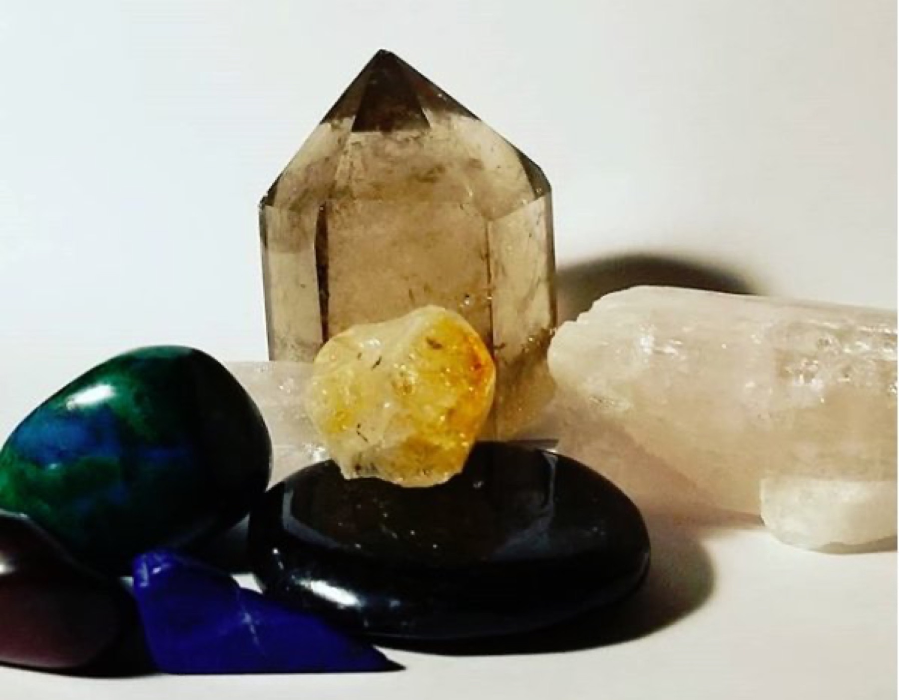 Assorted polished crystals in a retail display that a small crystal business might stock