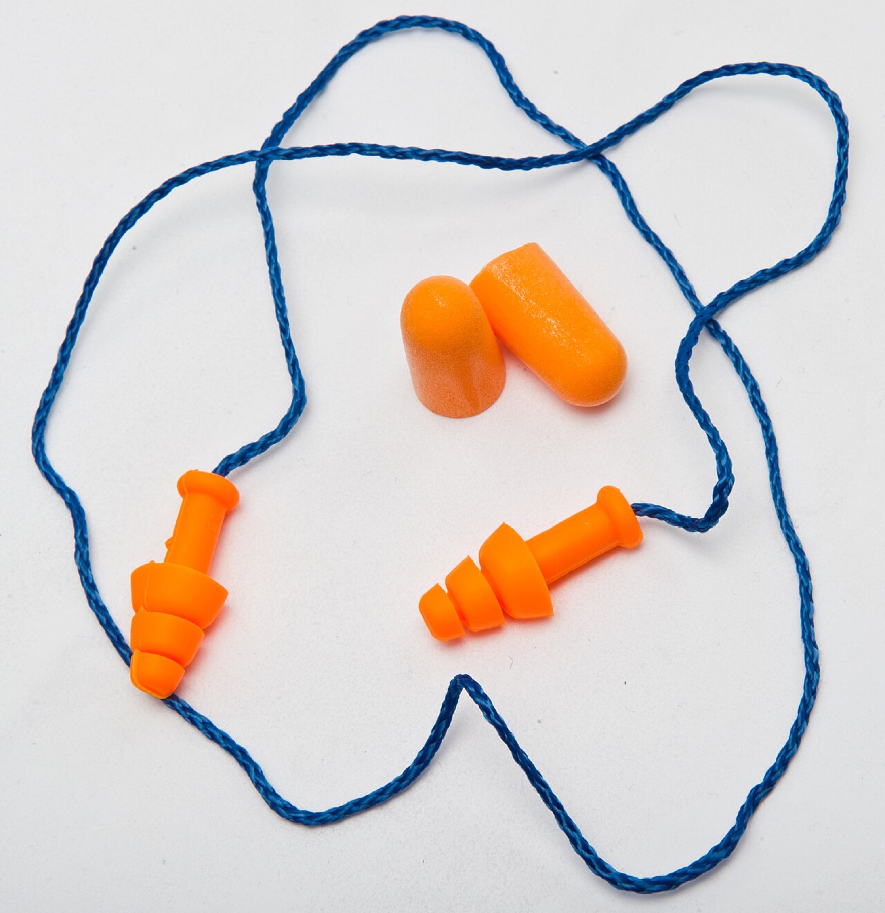 Single-use foam earplugs and reusable plugs side by side