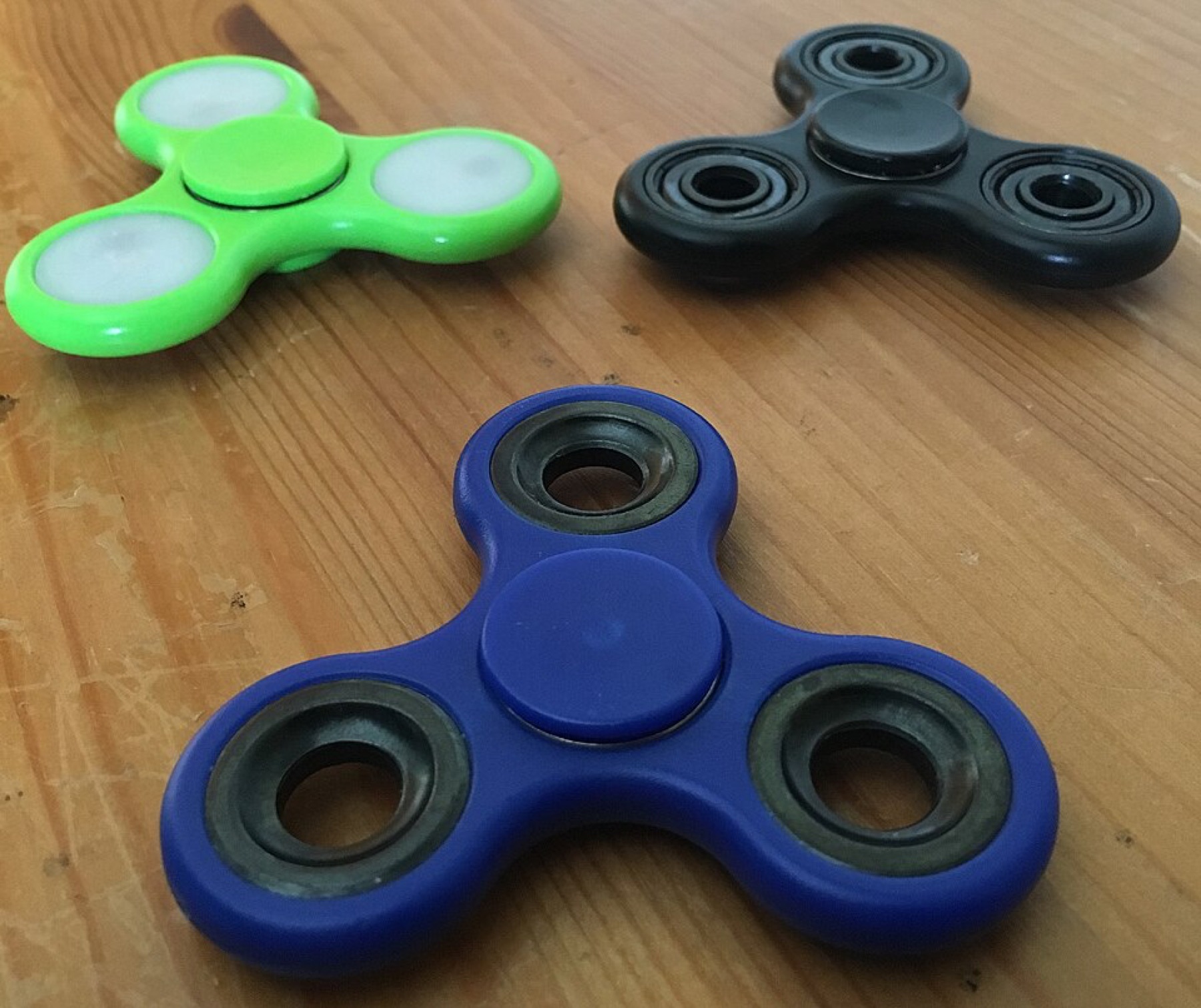 Assorted colorful fidget spinners in different shapes and materials