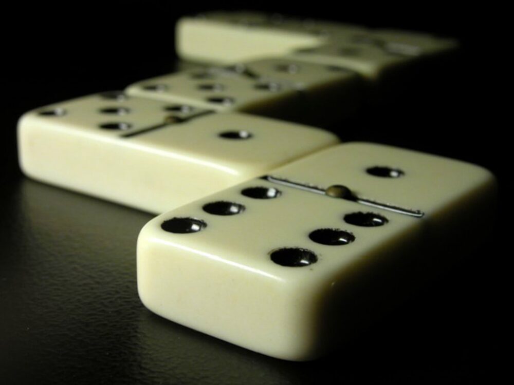 Black and white domino tiles scattered on a table