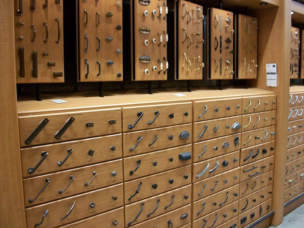 Assorted kitchen cabinet knobs and pulls mounted on display boards