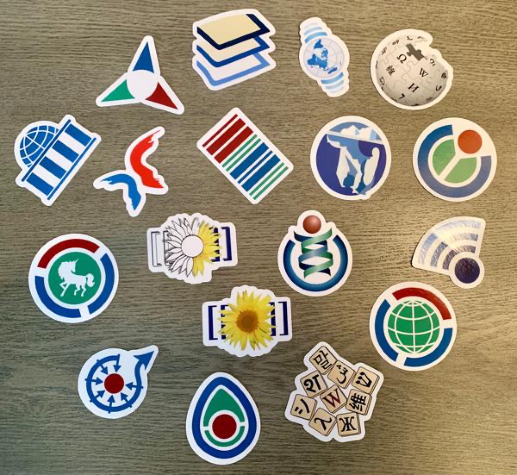 Assorted logo and project stickers spread on a table