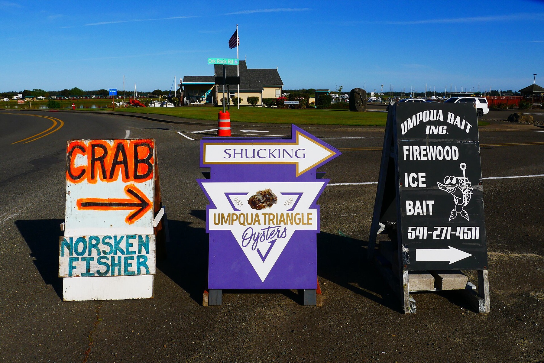 Outdoor A-frame sidewalk signs at a marina entrance