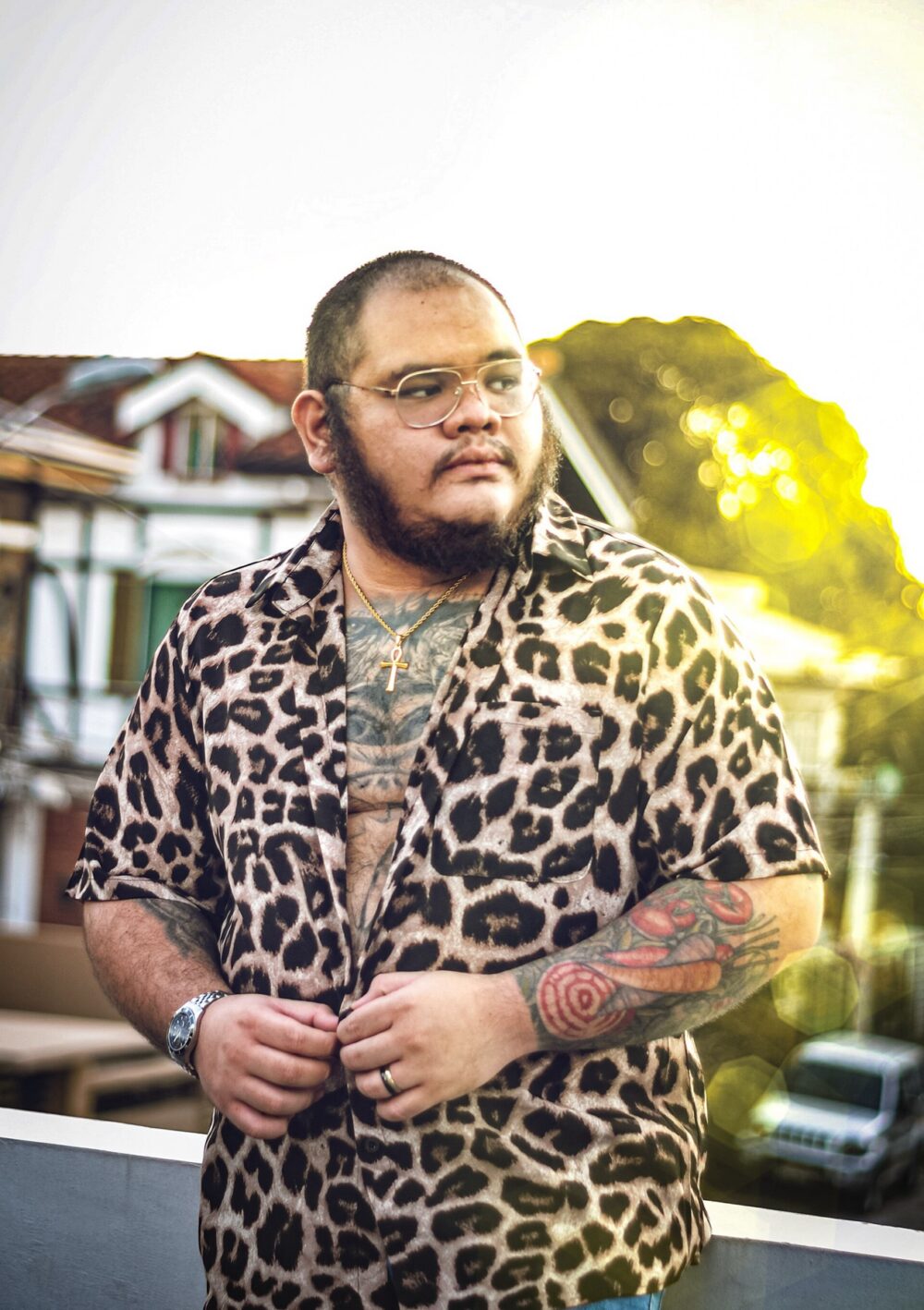Man wearing an animal-print shirt at sunset, illustrating character and animal tees