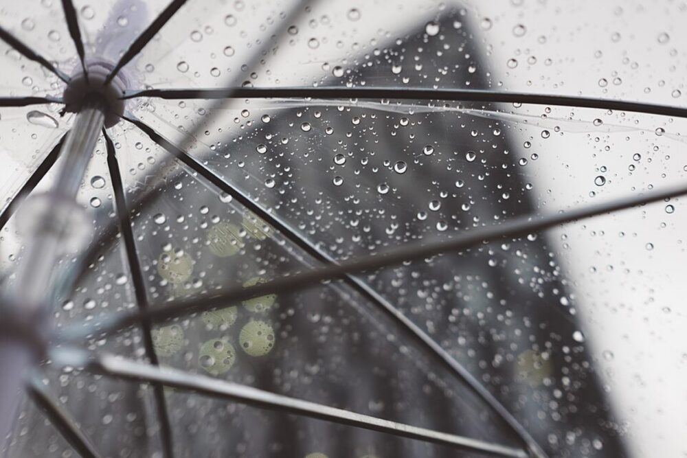 Person walking under a clear umbrella in the rain