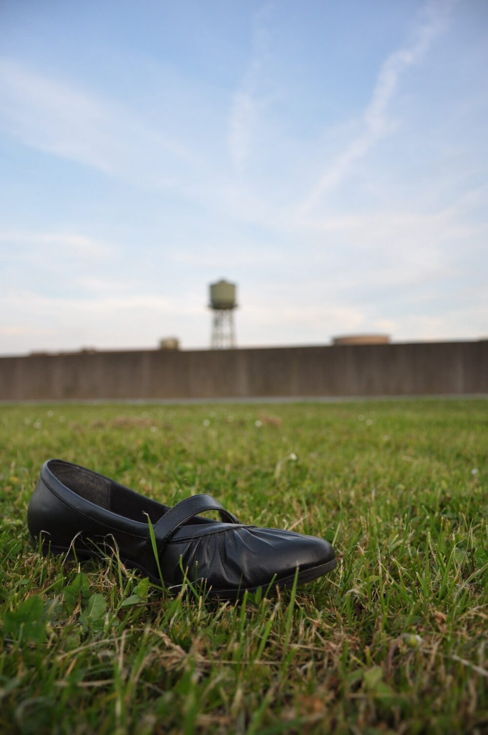 Close-up of a ballet flat resting on a paved surface, illustrating the type of shoe discussed in wholesale cost comparisons.