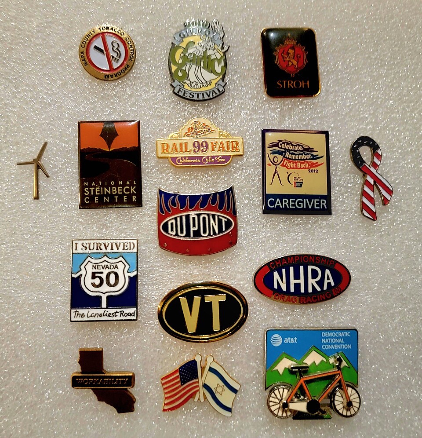 Assorted lapel pins displayed on a board