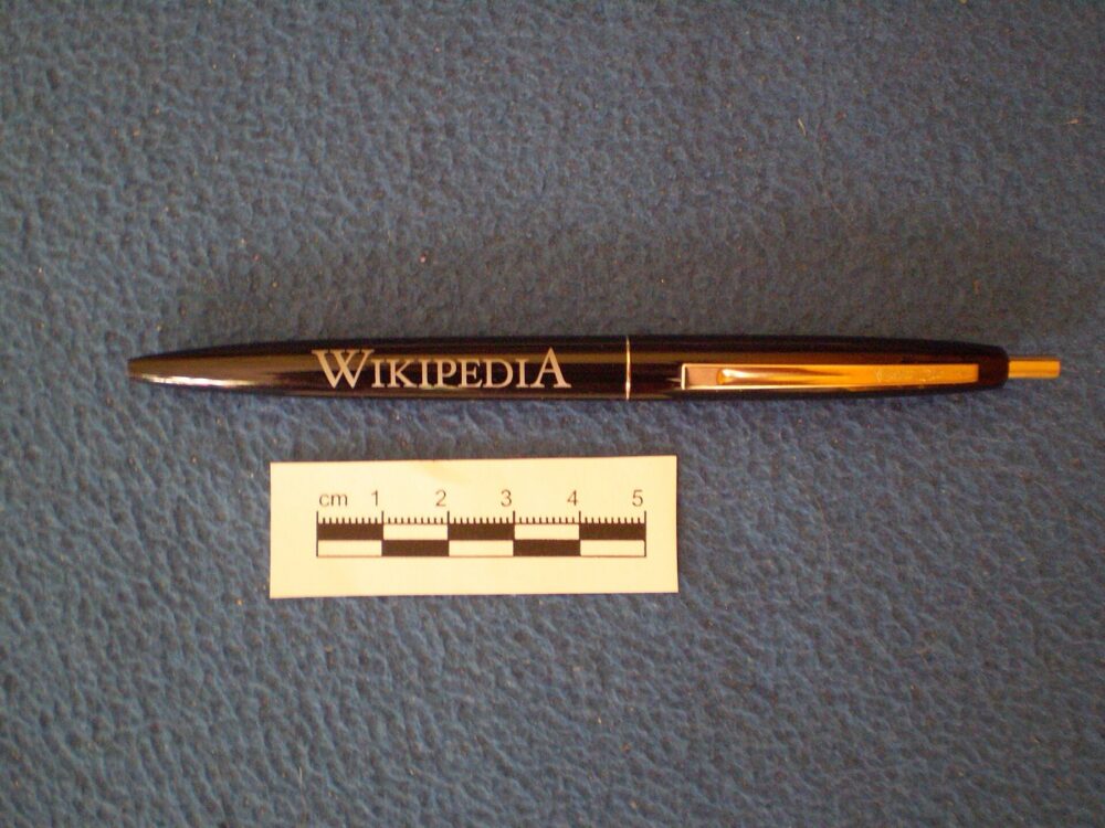 Assorted promotional pens on a table, illustrating low-cost bulk gifts