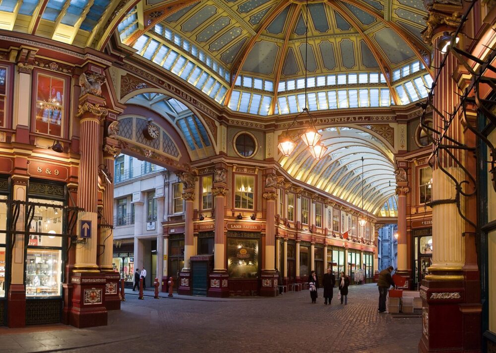 Covered indoor market arcade with shops and people walking