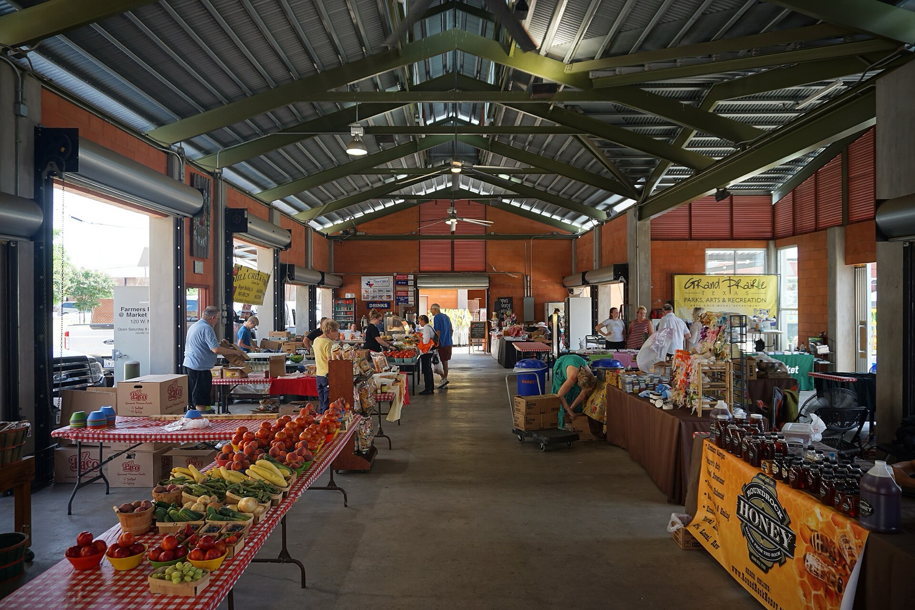 Farmers market stalls with fresh produce and plants