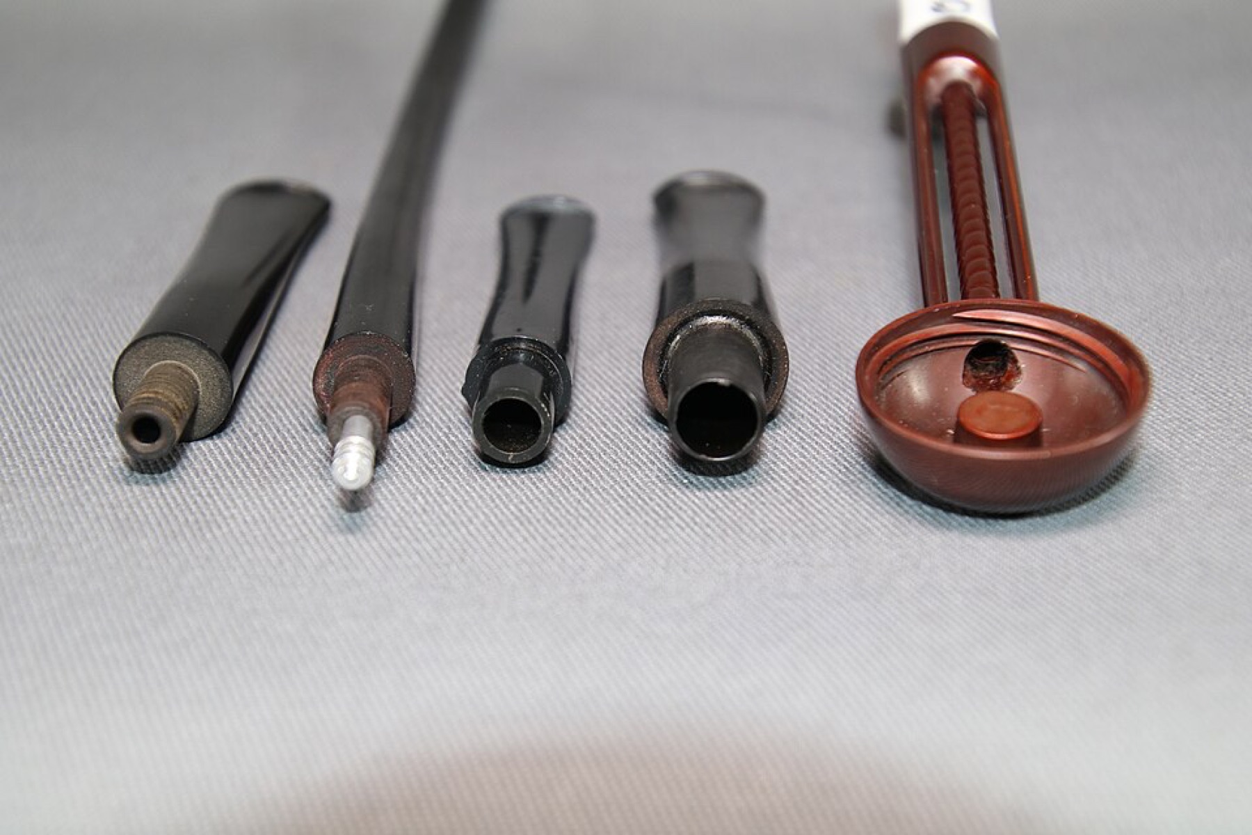 Assorted smoking pipe filter types laid out in rows
