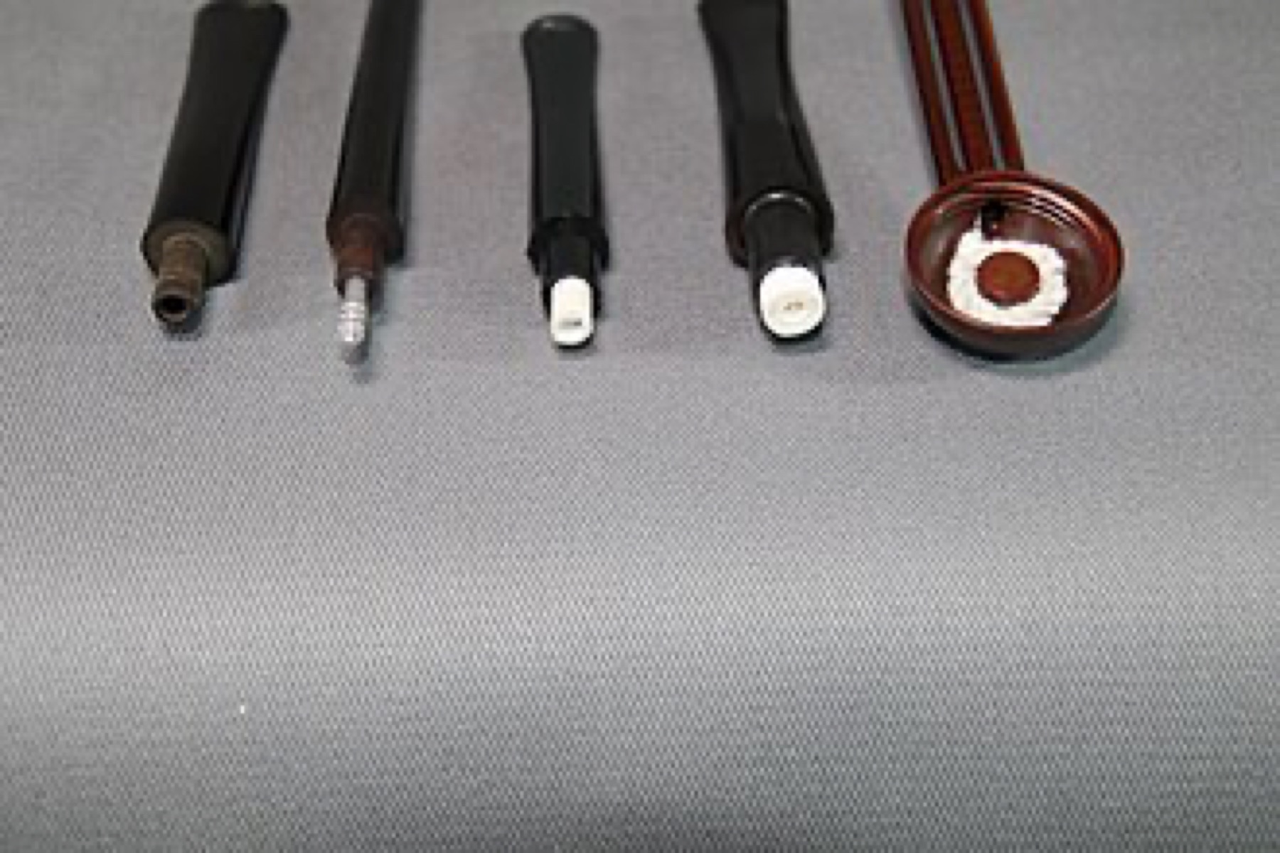 Glass and ceramic smoking filter types, including cylindrical and tapered designs, laid out side by side on a neutral background.