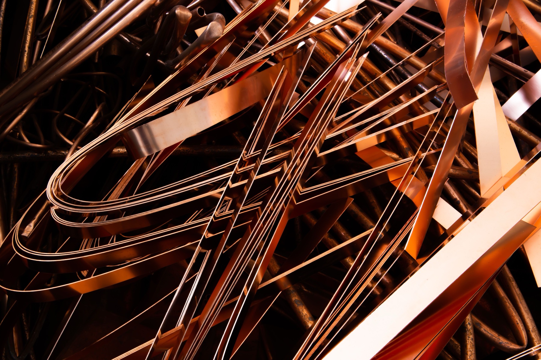 Stacks of copper sheets and coils stored in a warehouse for wholesale buyers