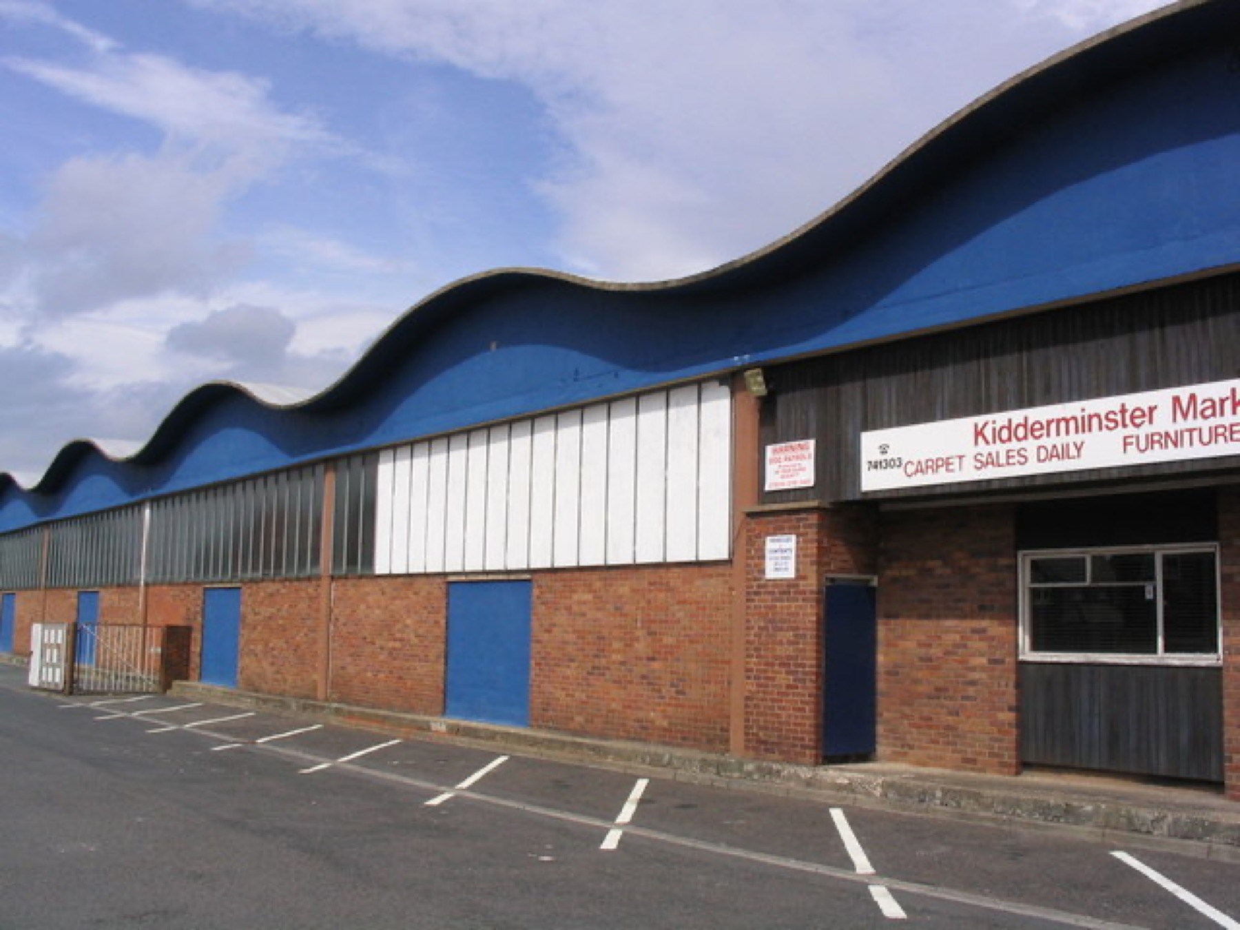 Exterior of a wholesale market building suggesting commercial trade and cost considerations.