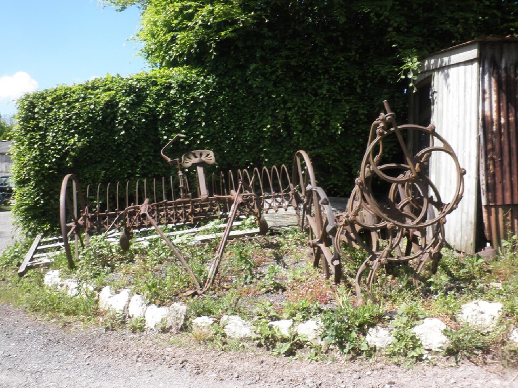 Vintage farm machinery lined up outdoors at a show