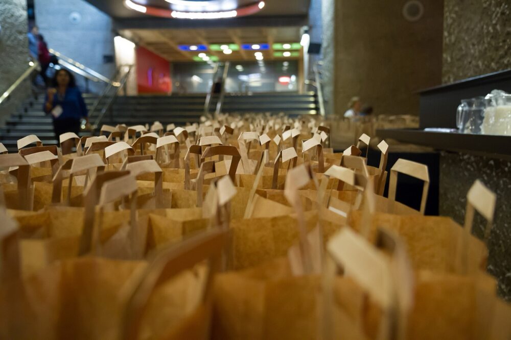 Assorted lunch bags lined up for event attendees
