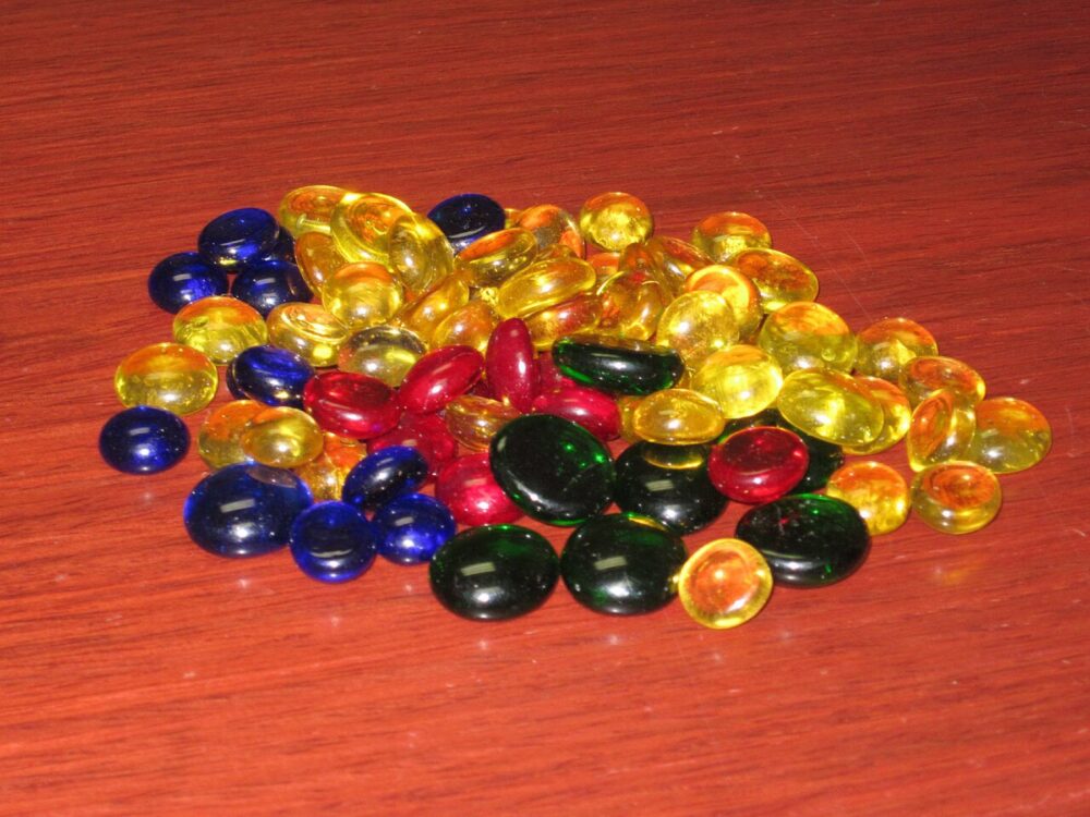 Mixed glass beads in various colors and sizes scattered together