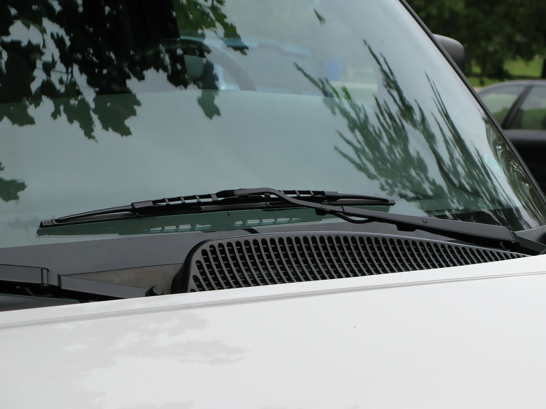 Close-up of a car’s windshield wiper on glass
