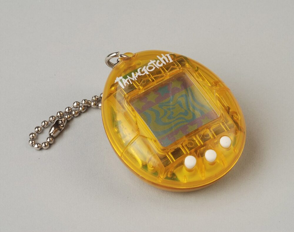 Yellow Tamagotchi device used as editorial illustration