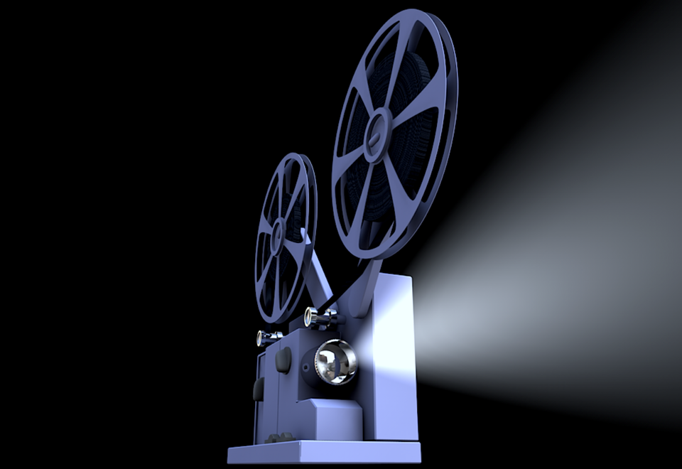 Vintage film projector sitting on a table, similar in style to classic 8mm projectors