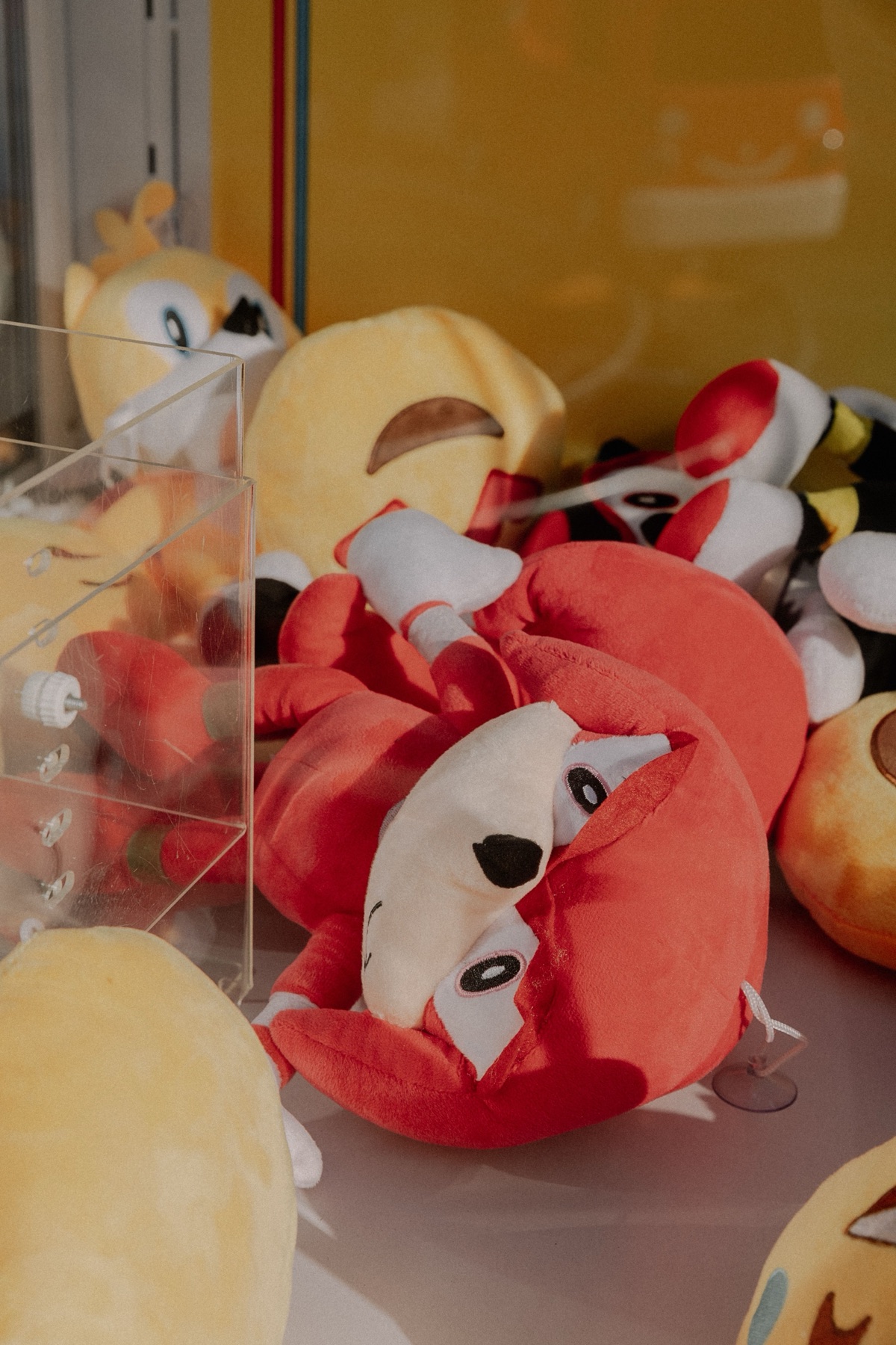 Soft plush toys in a claw machine, illustrating fandom plush variety