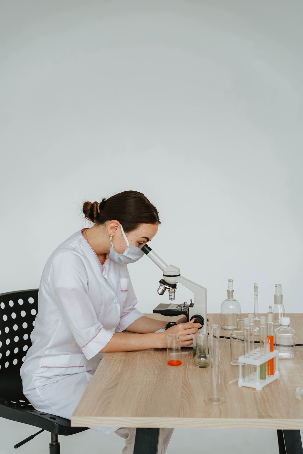 Laboratory technician working with equipment and glassware, illustrating the safety‑critical nature of lab suppliers