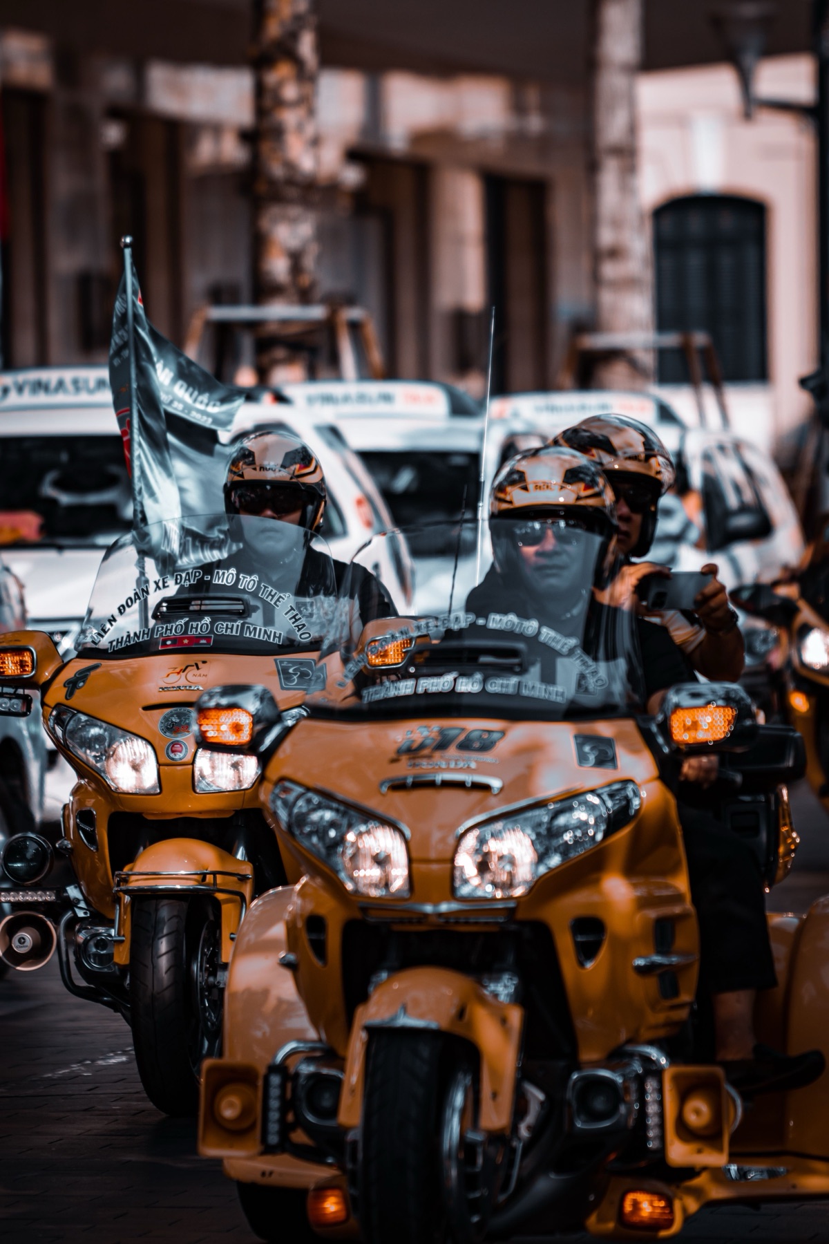 Group of riders on motorcycles in a city, representing different buyers sourcing moto gear in different ways