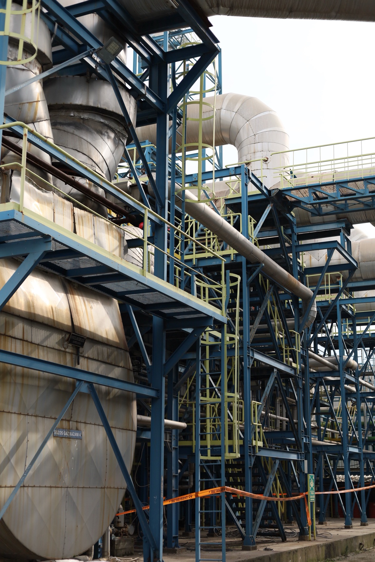 Factory building with industrial piping, illustrating high‑stakes equipment purchases